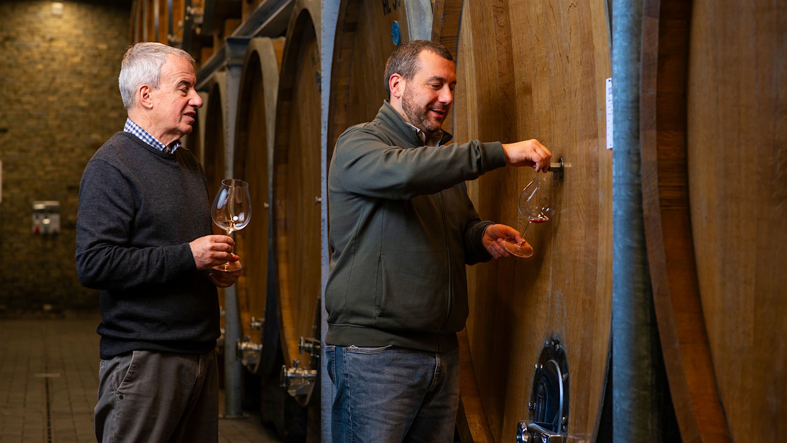 Director Aldo Vacca and winemaker Luca Cravanzola taste wine from the barrel at Produttori del Barbaresco in Barbaresco, Piedmont
